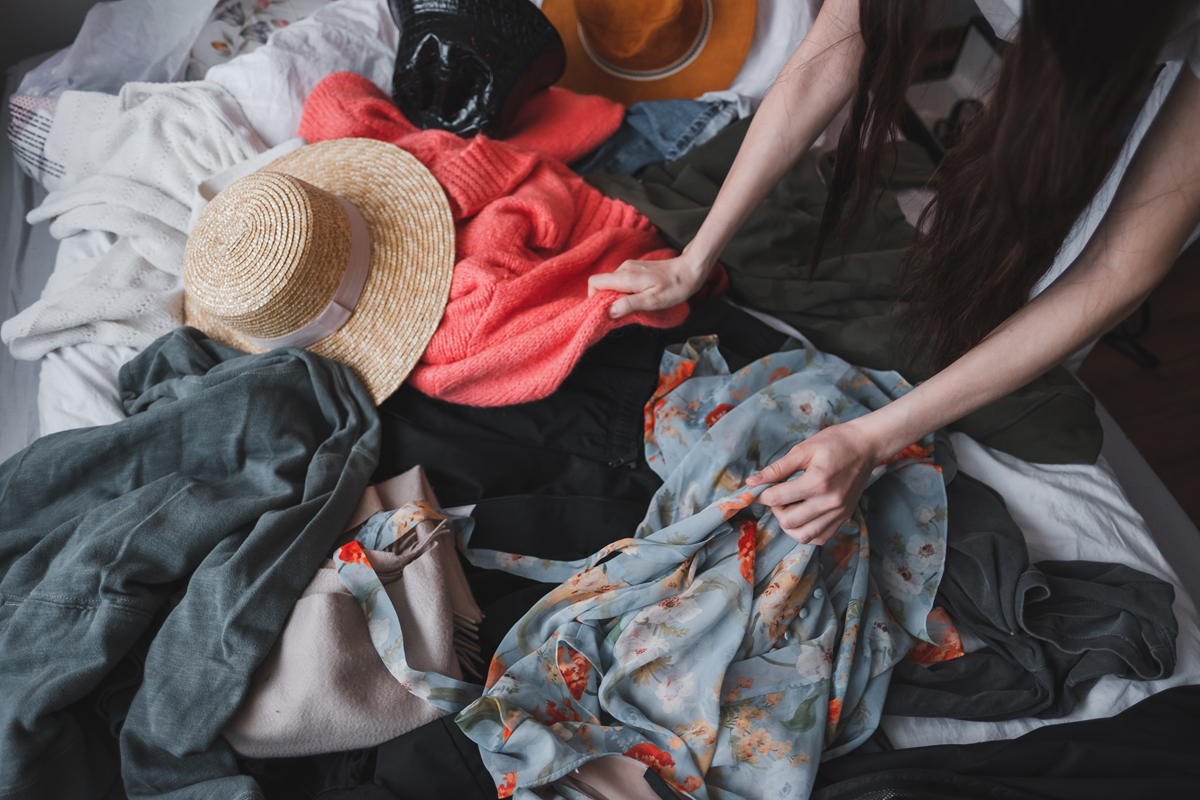 woman is sorting clothes and wardrobe at home 2023 11 27 05 09 56 utc